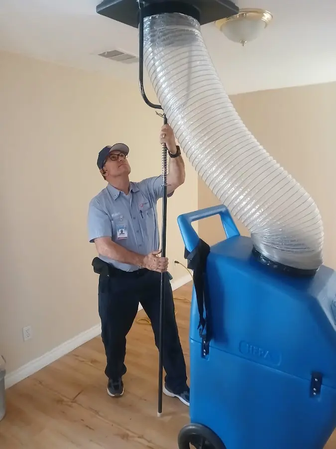 Furnace Tune-Up technician using HEPA equipment in Winter Park