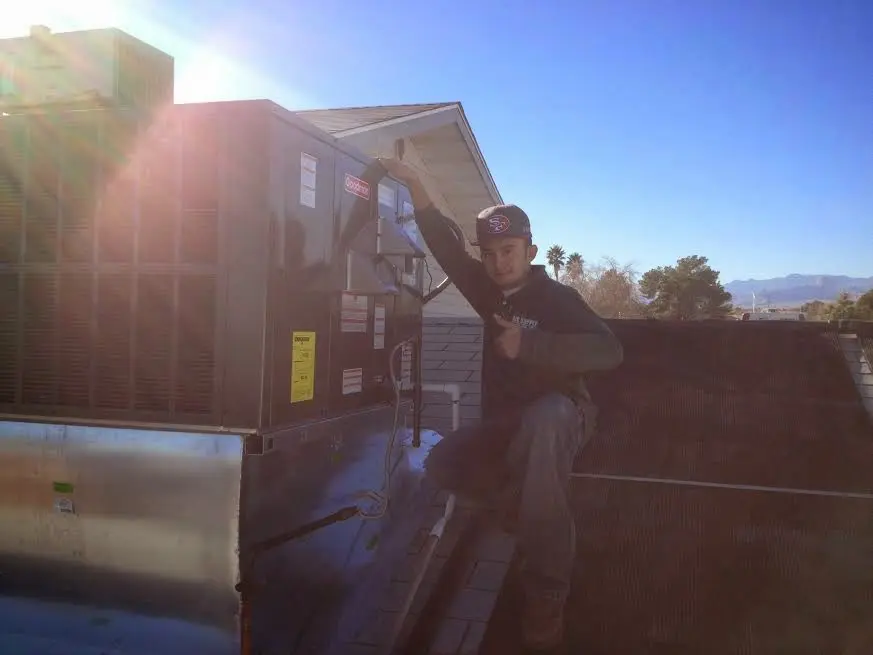 HVAC technician performing Boiler Repair on a rooftop unit in Winter Park